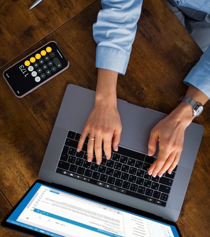 view-woman-typing-laptop (1)